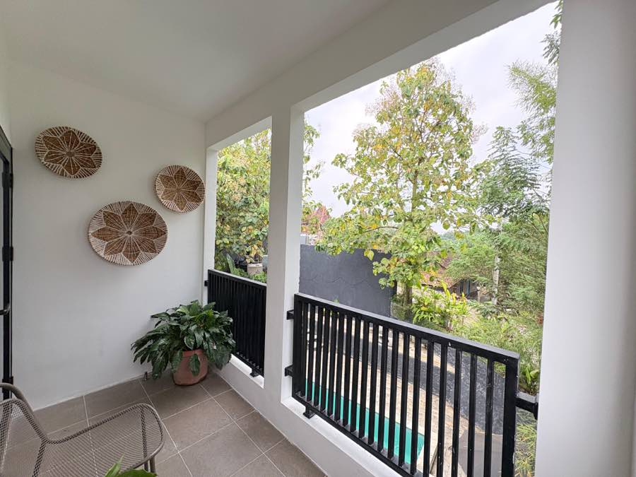 Balcony with chairs and a view over the trees