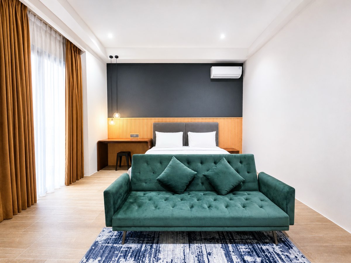 Bedroom with a king bed and a green velvet sofa bed