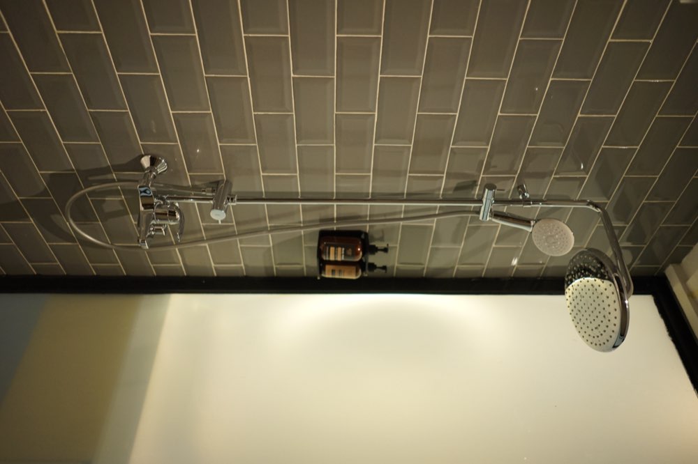 Rain shower against grey tiles
