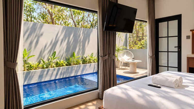 Bed facing glass doors onto the plunge pool